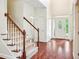 Foyer with hardwood floors, staircase, and front door with decorative glass at 214 Ashdown Forest Ln, Cary, NC 27519