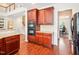 Kitchen with cherry cabinets, granite countertops, stainless appliances and a pass-through to office at 214 Ashdown Forest Ln, Cary, NC 27519