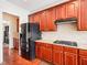 The kitchen has cherry cabinets, granite countertops and black stainless steel appliances at 214 Ashdown Forest Ln, Cary, NC 27519