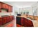 This kitchen features cherry cabinets, granite countertops and stainless steel appliances at 214 Ashdown Forest Ln, Cary, NC 27519