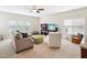 Comfortable living room featuring a sectional sofa, chairs, and a ceiling fan at 214 Ashdown Forest Ln, Cary, NC 27519
