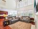 Bright and airy living room with large windows, hardwood floors, and cozy furniture, adjacent to the kitchen at 214 Ashdown Forest Ln, Cary, NC 27519