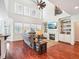 Sunlit living room with a fireplace, built-in bookshelves, and hardwood floors, creating a warm atmosphere at 214 Ashdown Forest Ln, Cary, NC 27519