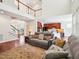 Open-concept living room featuring hardwood floors, a staircase, and a view into the kitchen area at 214 Ashdown Forest Ln, Cary, NC 27519