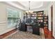 Home office features a large window, built-in bookshelves, and desk at 214 Ashdown Forest Ln, Cary, NC 27519