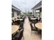 Community patio with neutral-colored tables, chairs, and decorative outdoor lighting at 214 Ashdown Forest Ln, Cary, NC 27519