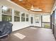 Screened porch with wooden ceiling and flooring, great for outdoor entertaining and grilling at 214 Ashdown Forest Ln, Cary, NC 27519