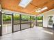 Covered screened porch with a wood ceiling, ceiling fan, and views of the backyard at 214 Ashdown Forest Ln, Cary, NC 27519
