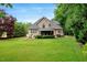 Lush green backyard with a patio and a fire pit, perfect for entertaining at 218 Kinvara Ct, Wake Forest, NC 27587