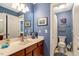 Traditional-style bathroom with wood cabinets, a sink, framed wall art and tiled flooring at 218 Kinvara Ct, Wake Forest, NC 27587