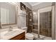 Modern bathroom featuring a vanity sink, toilet, glass shower, and stylish tile work at 218 Kinvara Ct, Wake Forest, NC 27587