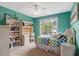Bright bedroom with a desk, shelving, and a window providing natural light at 218 Kinvara Ct, Wake Forest, NC 27587