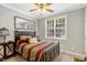 Comfortable bedroom with a queen-sized bed, bedside table, and a bright window at 218 Kinvara Ct, Wake Forest, NC 27587