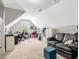 A large bonus room featuring a black leather sofa and an office workspace at 218 Kinvara Ct, Wake Forest, NC 27587