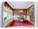 Formal dining room featuring a chandelier, large windows, and hardwood floors at 218 Kinvara Ct, Wake Forest, NC 27587