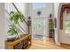 Elegant foyer featuring hardwood floors, staircase, and a decorative front door at 218 Kinvara Ct, Wake Forest, NC 27587