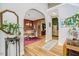 Inviting foyer showcasing hardwood floors, arched doorways, and views into the dining and living areas at 218 Kinvara Ct, Wake Forest, NC 27587