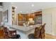 Stylish kitchen featuring granite countertops and wooden cabinets with ample seating at 218 Kinvara Ct, Wake Forest, NC 27587