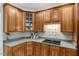 Kitchen with natural wood cabinetry, tile backsplash, and granite countertops at 218 Kinvara Ct, Wake Forest, NC 27587