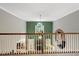 Open loft area showcasing a high ceiling, railing and a view of the foyer below at 218 Kinvara Ct, Wake Forest, NC 27587