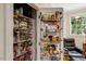 Walk-in pantry with shelving and door storage maximizes storage space at 218 Kinvara Ct, Wake Forest, NC 27587