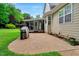 Stone patio and backyard featuring a grill and screened-in porch at 218 Kinvara Ct, Wake Forest, NC 27587
