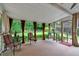 Relaxing screened-in porch featuring curtains, a ceiling fan, and outdoor seating at 218 Kinvara Ct, Wake Forest, NC 27587