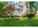 Backyard featuring a deck, fire pit, mature trees, and ample green space for outdoor activities and relaxation at 221 Roebling Ln, Cary, NC 27513