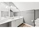 Well-lit bathroom with a dual sink vanity, a large mirror, and plenty of storage space at 221 Roebling Ln, Cary, NC 27513