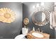 Stylish powder room featuring dark gray walls, decorative gold accents and marble countertop at 221 Roebling Ln, Cary, NC 27513