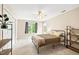Cozy bedroom with a ceiling fan, carpeted floors, and natural light from the windows at 221 Roebling Ln, Cary, NC 27513