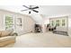 Expansive bonus room with vaulted ceilings features multiple desks, seating, and natural light at 221 Roebling Ln, Cary, NC 27513
