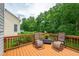 Relaxing deck with comfortable lounge chairs and views of the lush, tree-filled backyard at 221 Roebling Ln, Cary, NC 27513