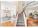 Open foyer with hardwood floors and staircase view of the dining room at 221 Roebling Ln, Cary, NC 27513