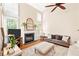 Cozy living room featuring a fireplace, plush seating, and neutral decor at 221 Roebling Ln, Cary, NC 27513