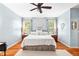 Calm main bedroom with light blue walls, hardwood floors, and decorative white accents at 221 Roebling Ln, Cary, NC 27513