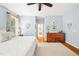 Spacious main bedroom with a view into the ensuite bathroom and a wooden dresser at 221 Roebling Ln, Cary, NC 27513