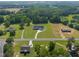 Stunning aerial view of a beautiful home on a large lot, surrounded by lush greenery and mature trees at 2229 Neills Creek Rd, Lillington, NC 27546