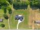 Bird's-eye view of farmhouse-style home featuring a large lawn, long driveway, and mature trees at 2229 Neills Creek Rd, Lillington, NC 27546