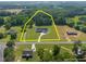 Aerial view of a sprawling property showcasing a farmhouse, outbuildings, and estimated property lines at 2229 Neills Creek Rd, Lillington, NC 27546