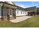 Backyard stone patio showcasing steps to dual screened-in porches on a charming farmhouse at 2229 Neills Creek Rd, Lillington, NC 27546