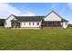 Expansive green backyard showcasing a charming farmhouse with two screened-in porches at 2229 Neills Creek Rd, Lillington, NC 27546