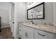 Bathroom featuring a granite countertop vanity with updated fixtures and a framed mirror at 2229 Neills Creek Rd, Lillington, NC 27546