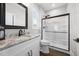 Modern bathroom with a sink and shower combo, marble countertop and black hardware at 2229 Neills Creek Rd, Lillington, NC 27546