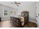 Cozy bedroom with rustic decor, a ceiling fan, and natural light from the windows at 2229 Neills Creek Rd, Lillington, NC 27546