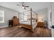 Stylish bedroom with a four-poster bed, wooden furniture, and ample natural light at 2229 Neills Creek Rd, Lillington, NC 27546