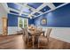 Cozy dining room with coffered ceiling, blue accent wall, and classic wainscoting at 2229 Neills Creek Rd, Lillington, NC 27546