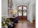 Elegant entryway with wood floors, a decorative console table, and arched double doors with wreaths at 2229 Neills Creek Rd, Lillington, NC 27546