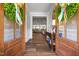 Inviting entryway featuring wood floors, decorative wreaths on doors, and a view into the spacious living room at 2229 Neills Creek Rd, Lillington, NC 27546