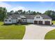 Charming white farmhouse-style home featuring a long driveway and well-manicured landscaping at 2229 Neills Creek Rd, Lillington, NC 27546